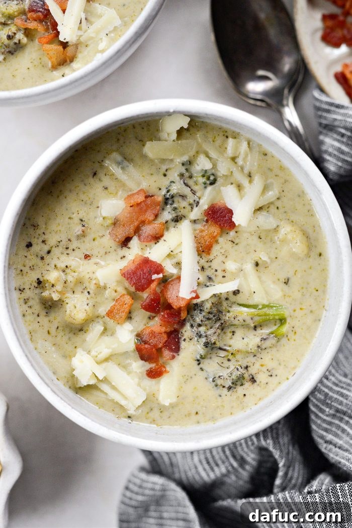 Creamy Roasted Broccoli Cauliflower Soup topped with bacon and cheddar
