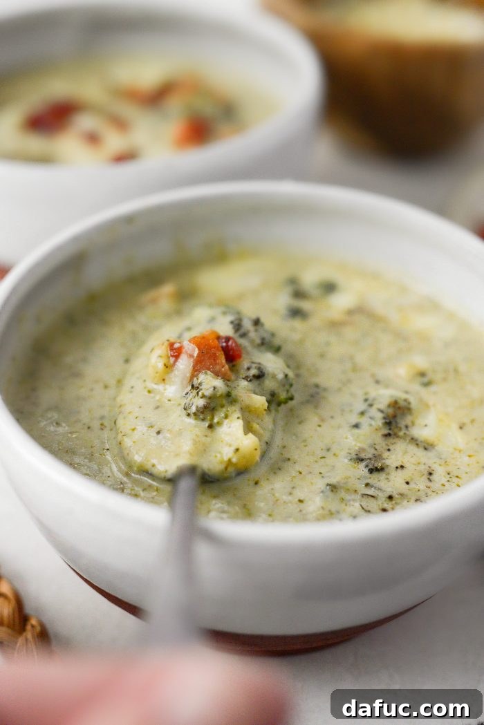 Serving of Roasted Broccoli Cauliflower Soup with crispy bacon and grated cheddar