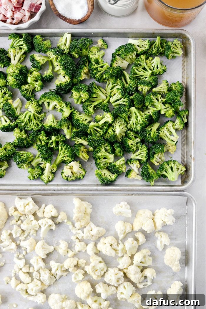 Broccoli and cauliflower florets on parchment-lined baking sheets