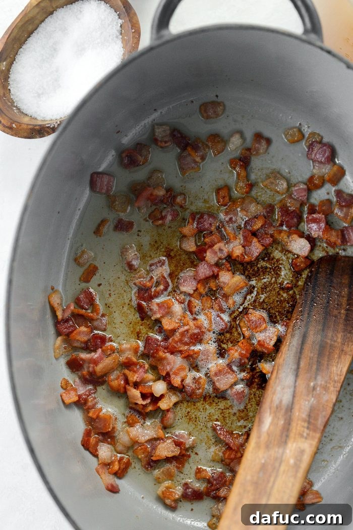 Crispy diced bacon draining on a paper towel
