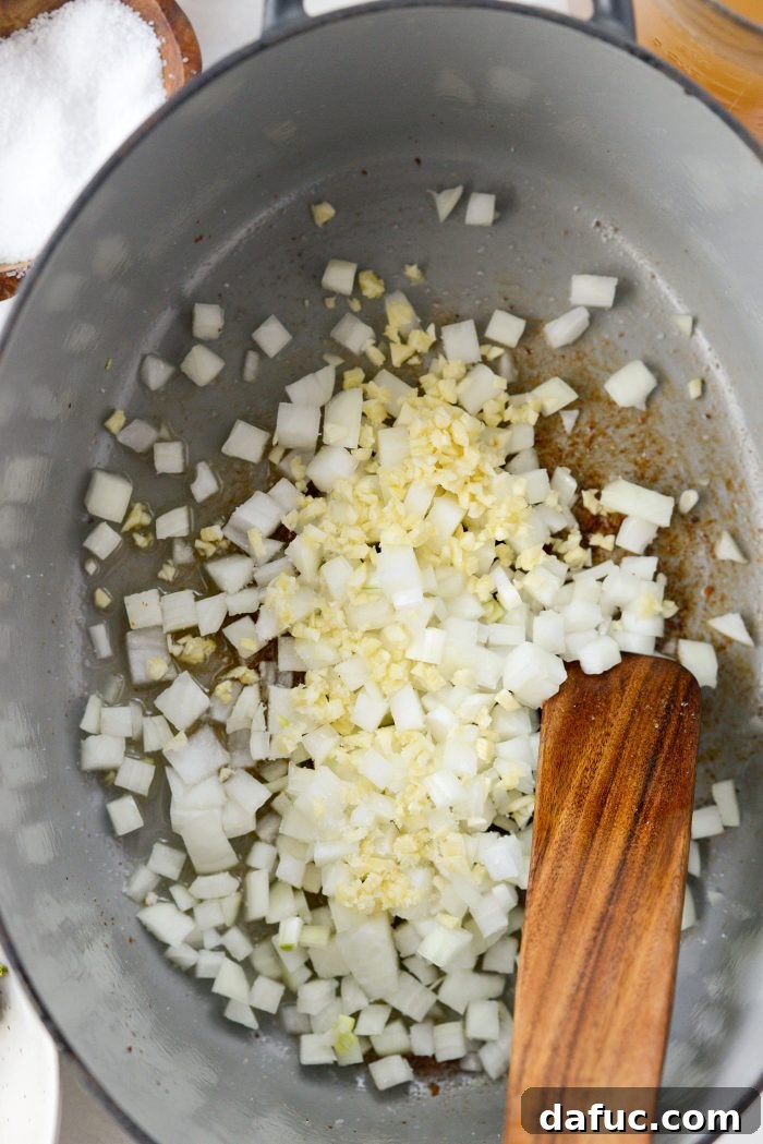 Diced onion and minced garlic sautéing in bacon fat
