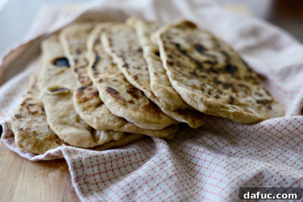 Pillowy Naan Perfection at Home 2 Homemade Naan Bread - The easiest and most delicious bread you can make at home for curries, wraps, or dips.