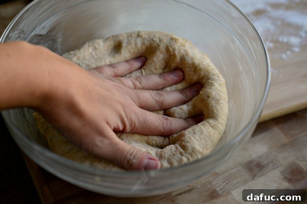 Pillowy Naan Perfection at Home 23 Naan dough being punched down to release air after its first rise.