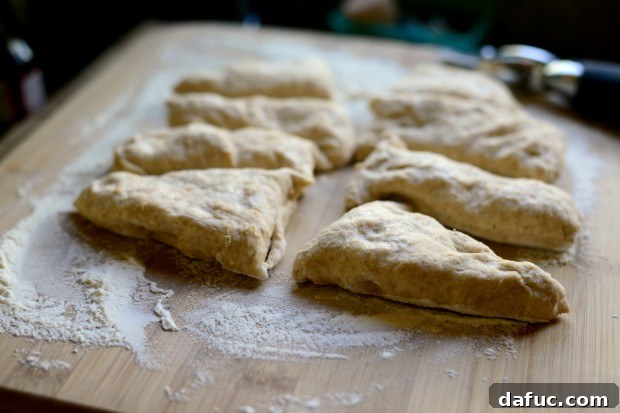 Pillowy Naan Perfection at Home 25 Naan dough cut into eight triangular pieces, ready for rolling.
