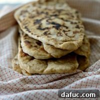 Pillowy Naan Perfection at Home 35 Homemade Naan Bread - The easiest and most delicious bread you can make at home for curries, wraps, or dips.