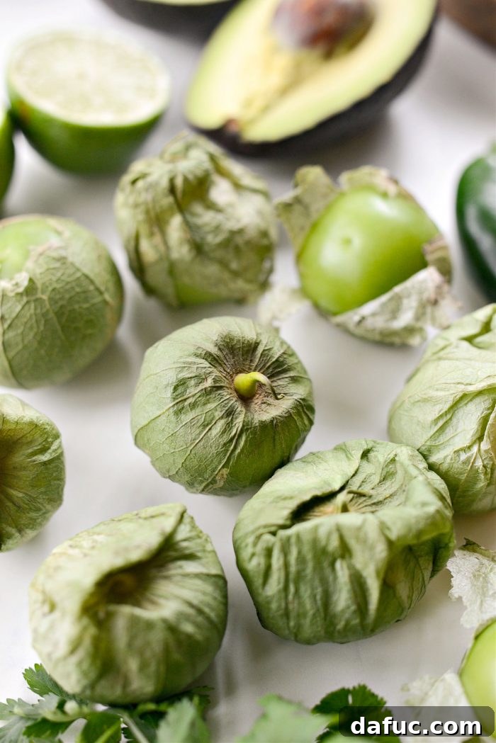 Zesty Tomatillo Avocado Salsa 5 Close up photo of fresh tomatillos with husks.