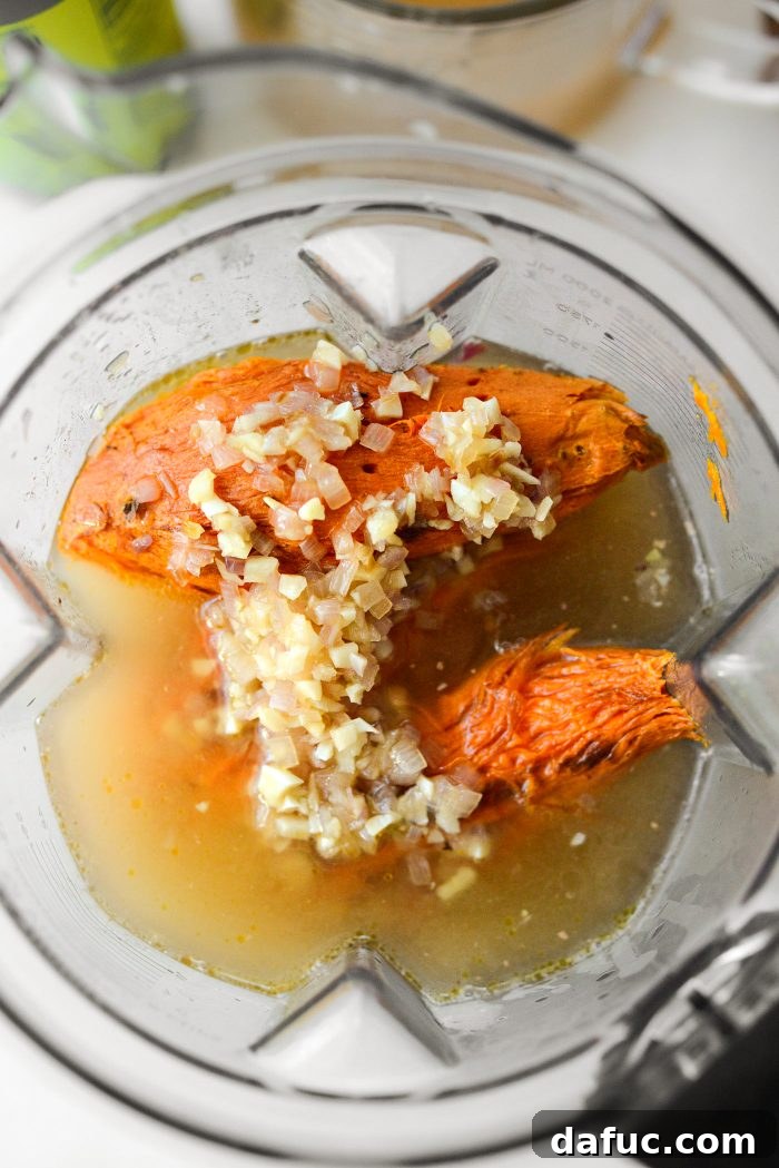 Vibrant Sweet Potato Tomatillo Bisque 13 1.5 cups of broth being poured into the blender with roasted vegetables