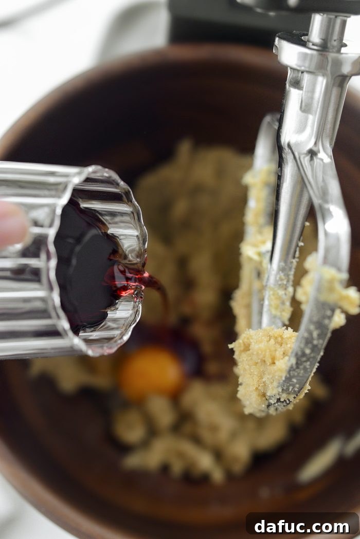 Decadent Merlot-Infused Dark Chocolate Cookies 11 Half a cup of Merlot red wine being poured into the stand mixer bowl.