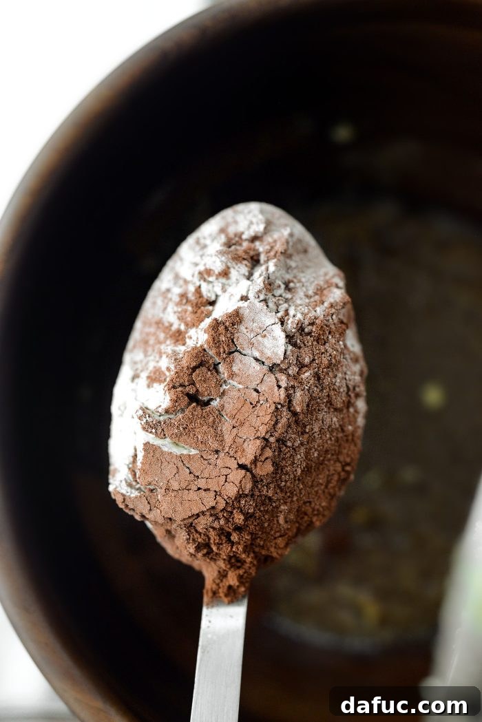 Decadent Merlot-Infused Dark Chocolate Cookies 13 Gradually adding sifted dry ingredients into the wet mixture in the stand mixer.