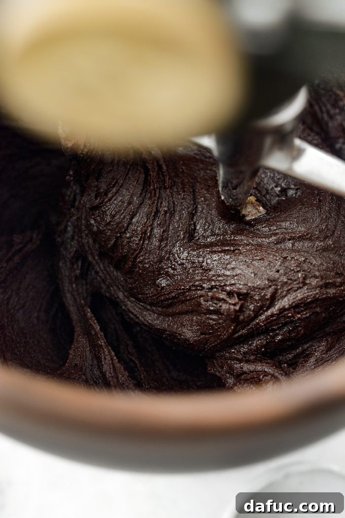Decadent Merlot-Infused Dark Chocolate Cookies 14 The cookie dough thickening and darkening as dry ingredients are mixed in.