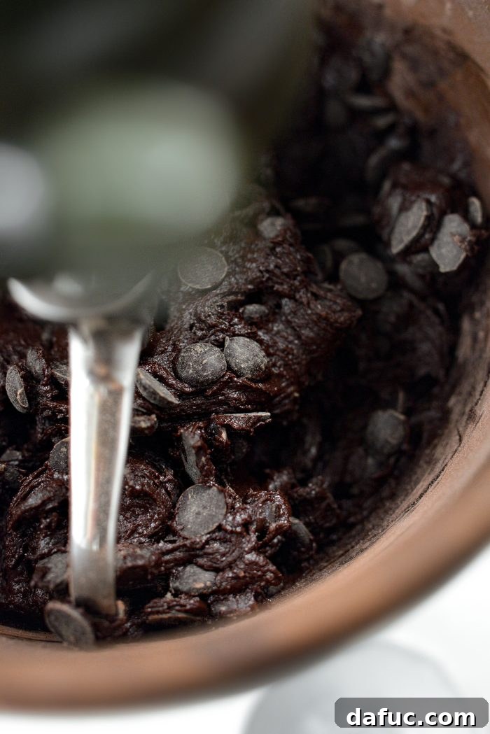 Decadent Merlot-Infused Dark Chocolate Cookies 16 The chocolate chips being gently mixed into the dark chocolate merlot cookie dough.