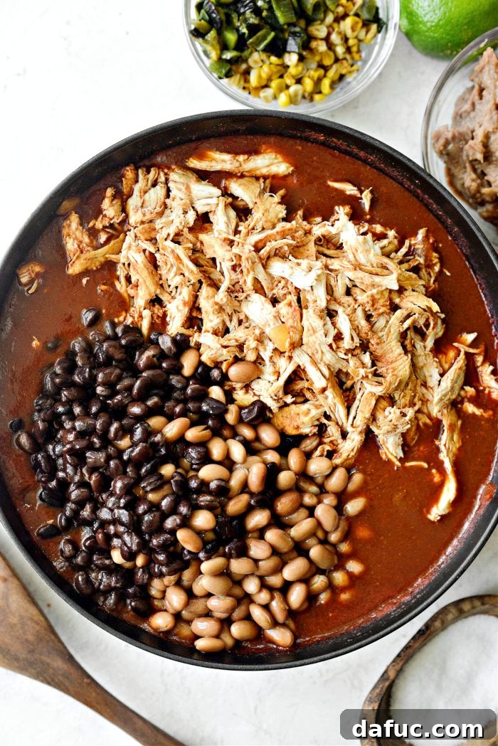 Shredded chicken, pinto beans, and black beans added back to the pot
