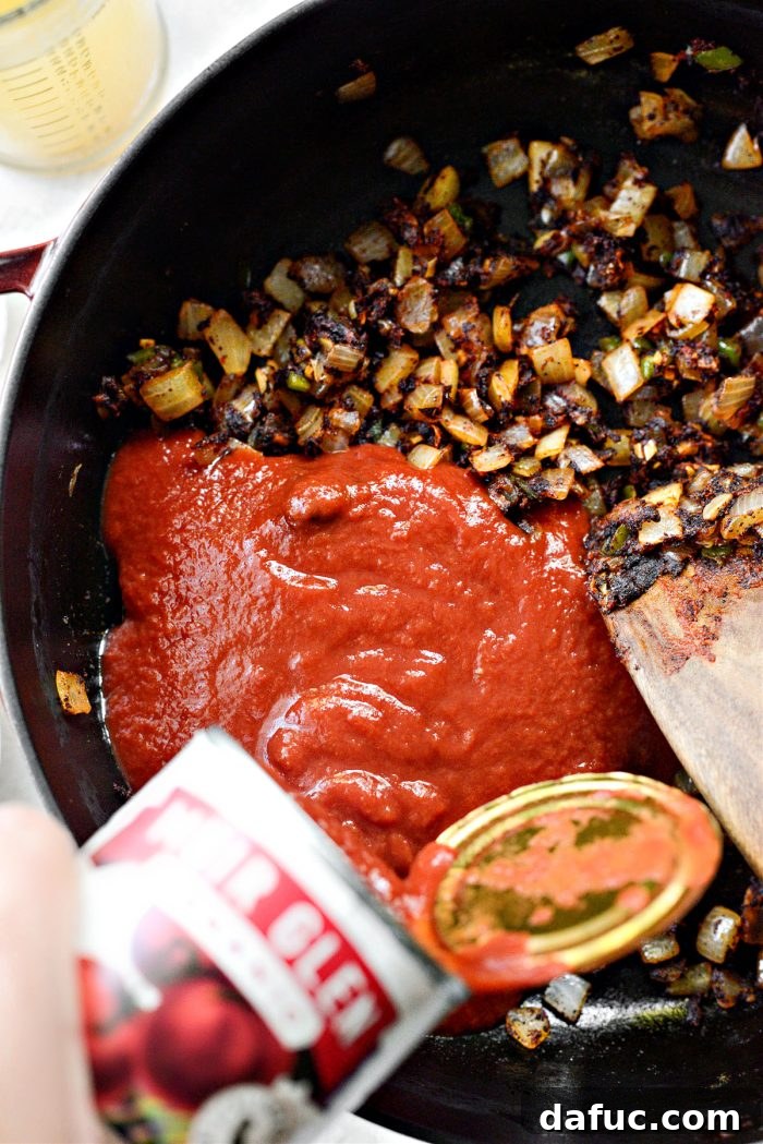 Smoky Southwest Chicken Chili 7 Pouring two cans of tomato sauce into the pot