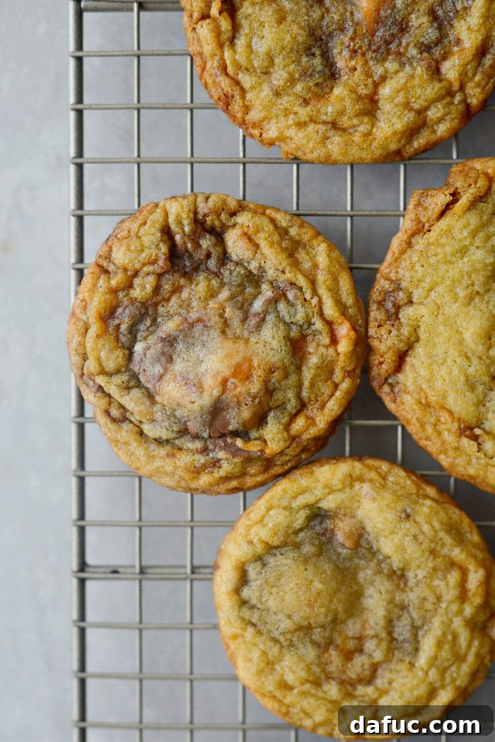 Another view of Butterfinger cookies cooling on a wire rack.