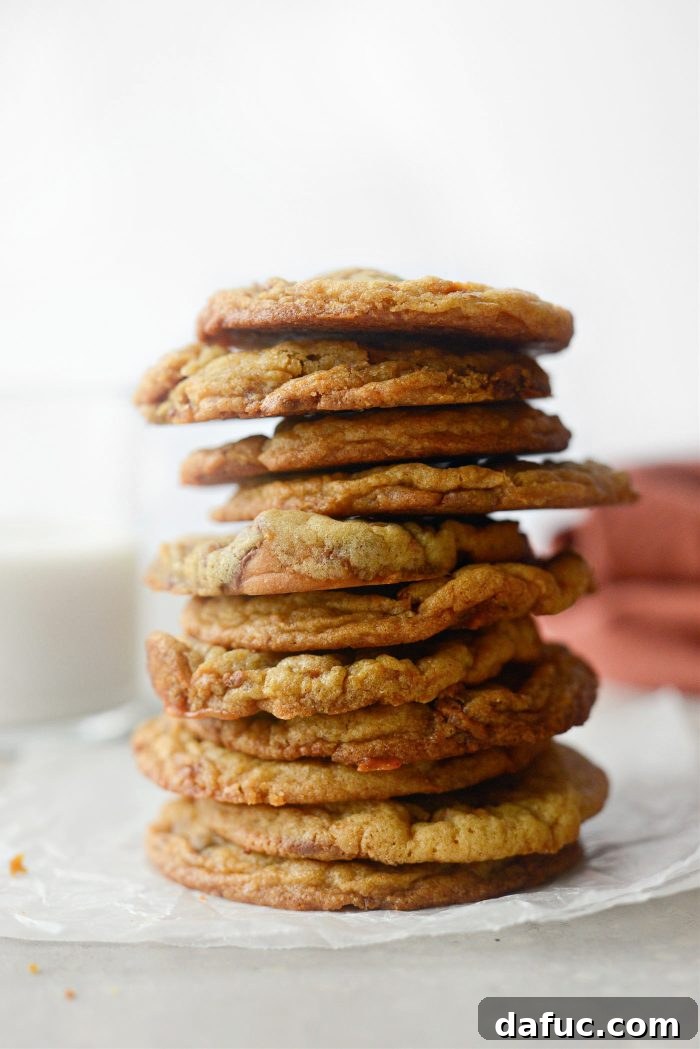 A stack of golden-brown Butterfinger Cookies with visible candy pieces.