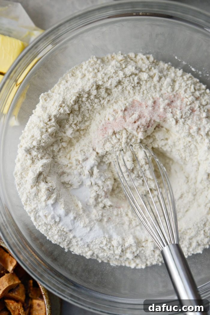 Dry ingredients (flour, baking soda, salt) being whisked together in a bowl.