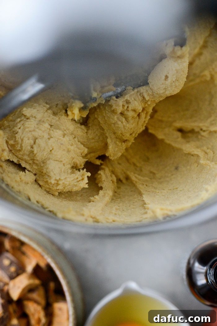 Creamed butter and sugars in a stand mixer bowl, showing a light and fluffy texture.