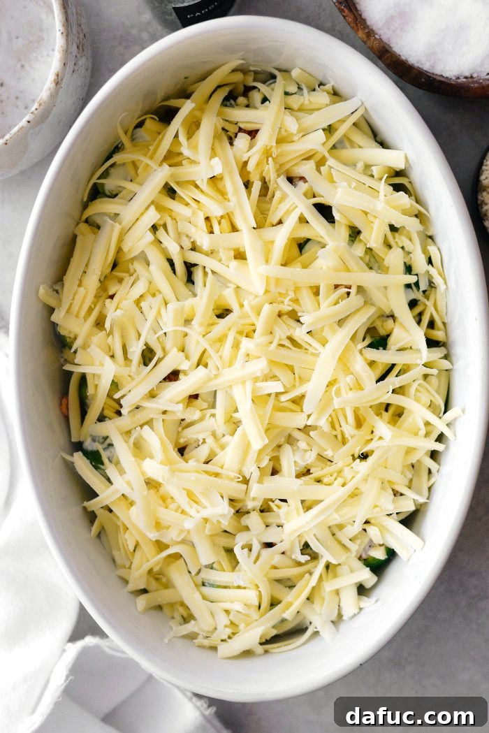 Creamy Cheesy Brussels Sprout Bake 6 Topping the Brussels sprout gratin with shredded white cheddar cheese.