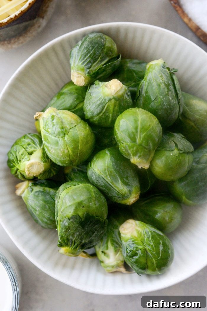 Creamy Cheesy Brussels Bake 5 Preparing fresh Brussels sprouts by removing tough outer leaves