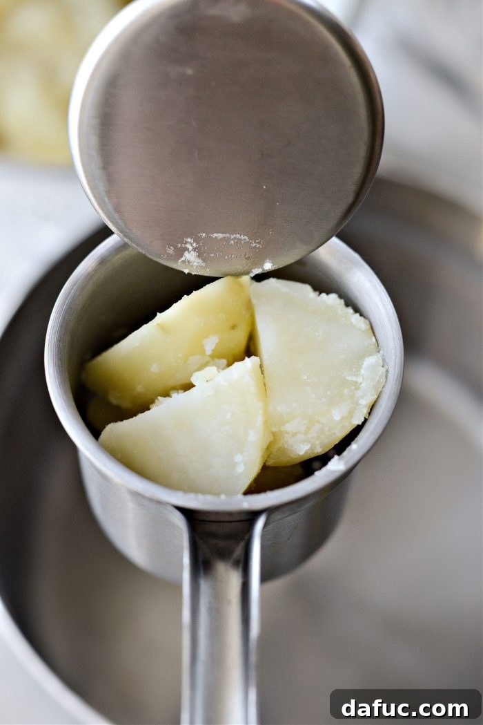 Heirloom Mashed Potatoes 12 add cooked potatoes to a ricer - cooked potatoes loaded into a potato ricer