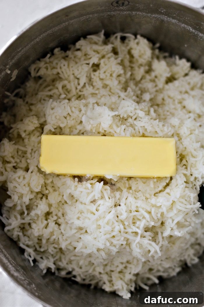 Heirloom Mashed Potatoes 15 add butter to riced potatoes - cubes of butter being added to riced potatoes