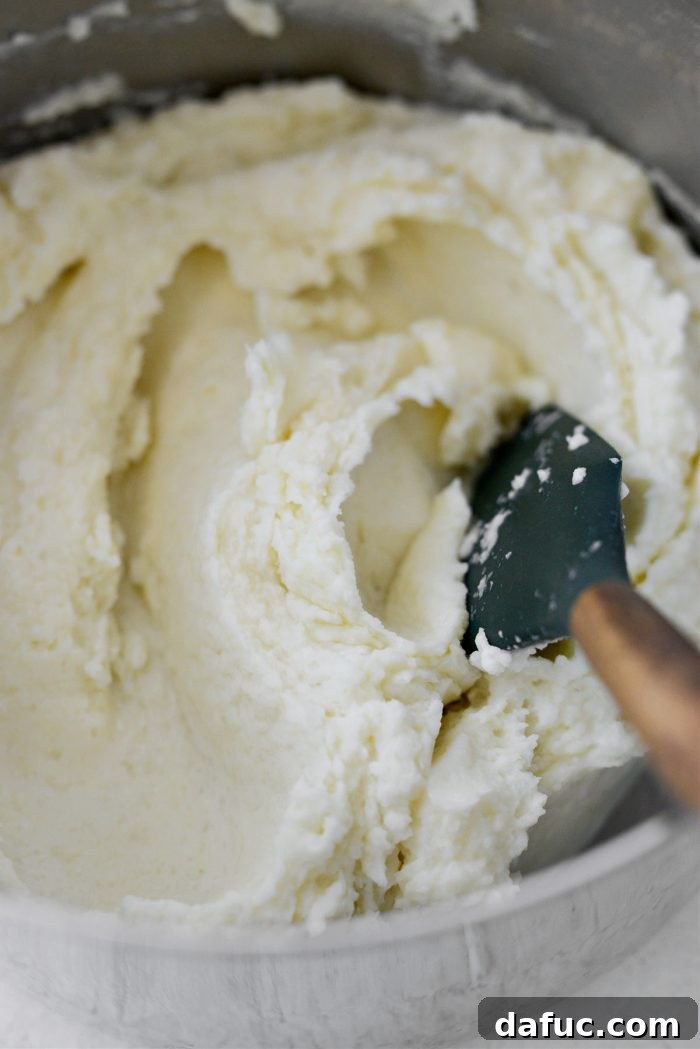 Heirloom Mashed Potatoes 17 stir to combine - mashed potatoes being stirred in a pot