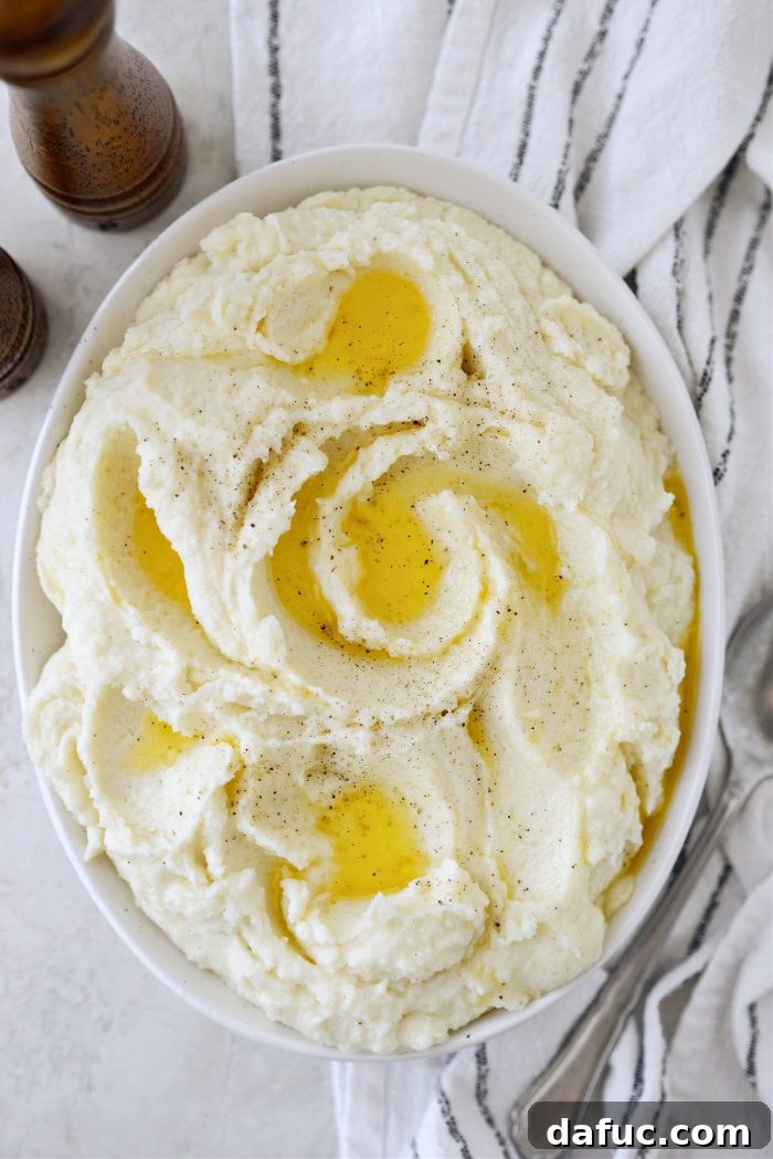Heirloom Mashed Potatoes 20 drizzle with melted salted butter and add extra black pepper - garnished mashed potatoes in a serving bowl