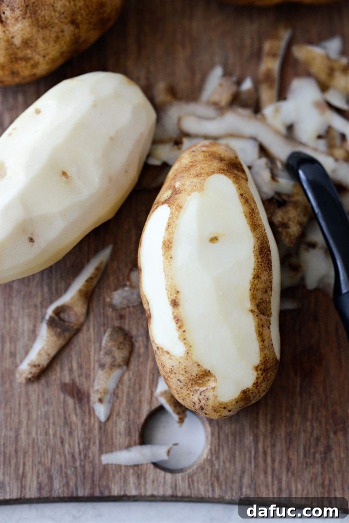 Heirloom Mashed Potatoes 5 peeling potatoes - hands peeling russet potatoes