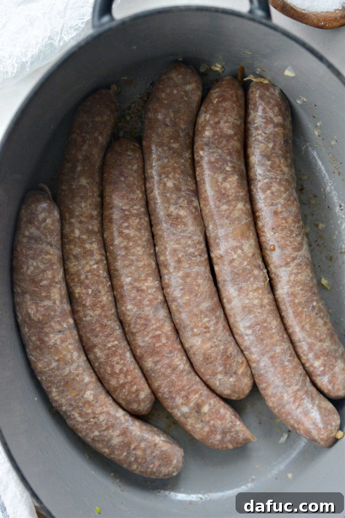 Dublin's Hearty Comfort Coddle 11 Pork sausages being added to the bacon fat in the Dutch oven for searing.