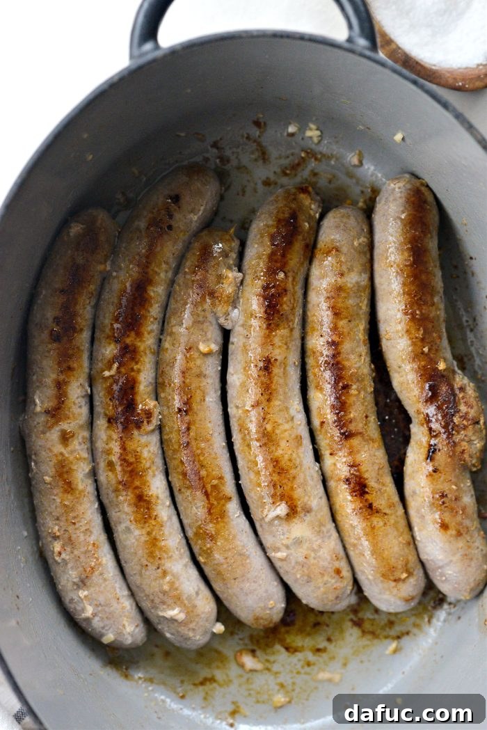 Dublin's Hearty Comfort Coddle 12 Browned pork sausages resting in the Dutch oven after searing.