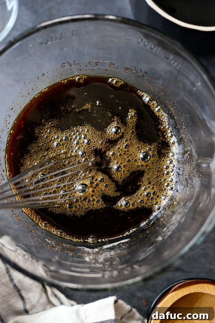 Whisking all ingredients together until well combined.
