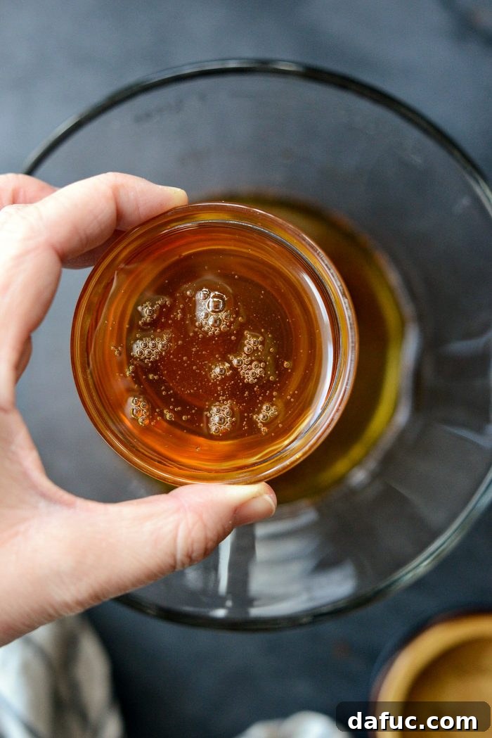 Pouring honey into the sauce mixture.