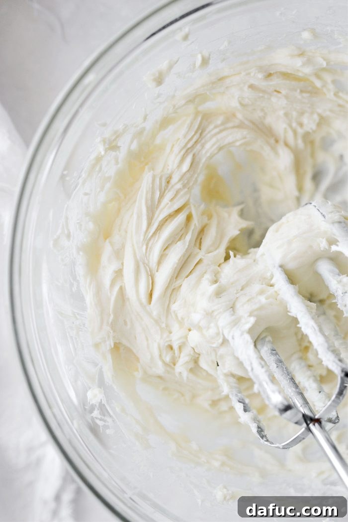 Mixing cream cheese filling until smooth