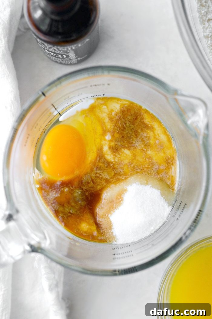 Adding wet ingredients to a bowl for muffin batter