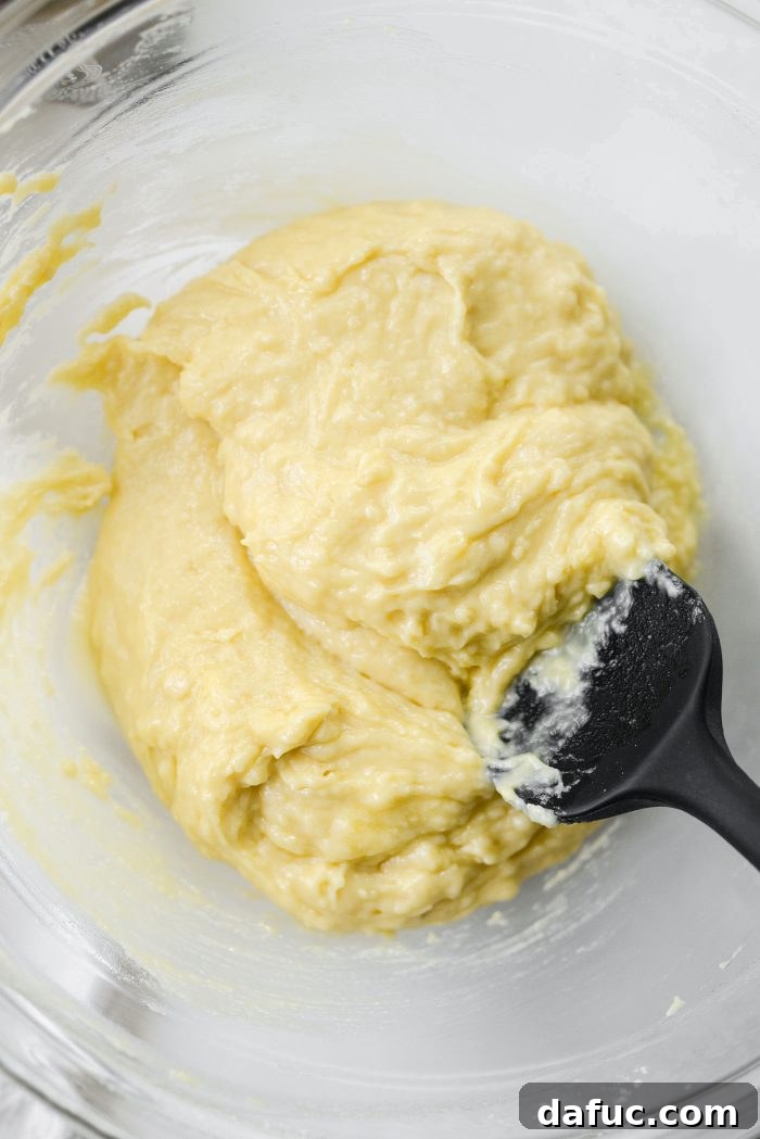 Mixing melted butter into muffin batter
