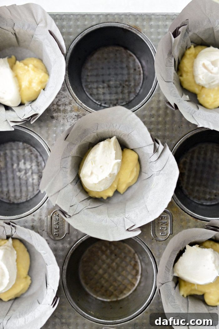 Adding muffin batter and cream cheese filling to liners
