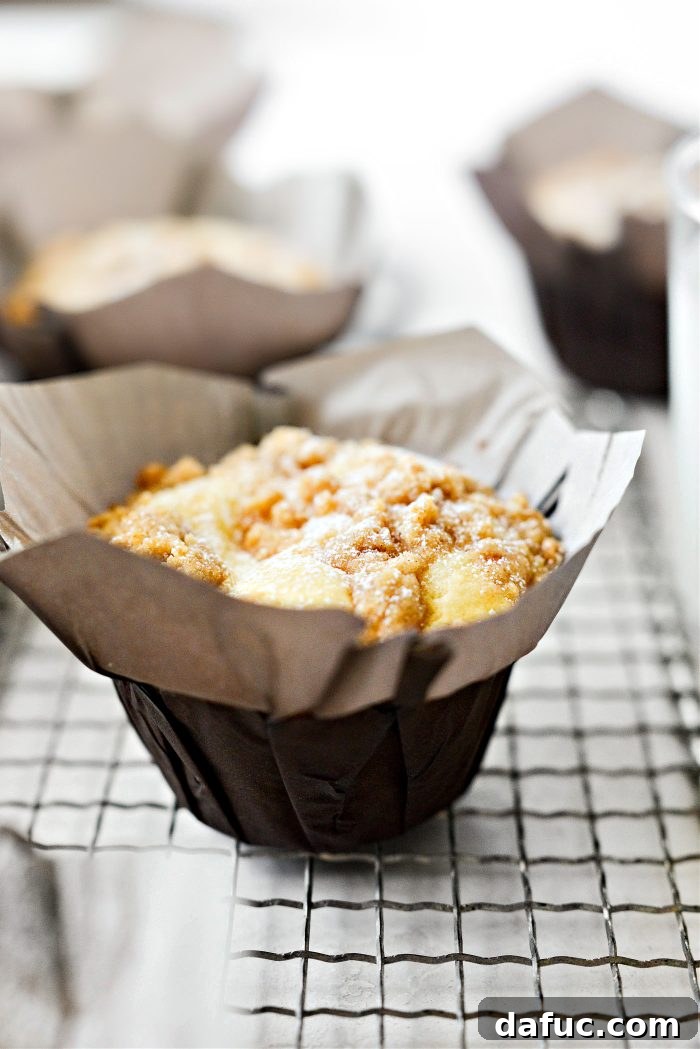 Freshly baked Cream Cheese Streusel Muffins on a wire rack