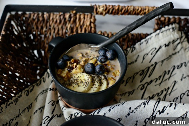 Banana Bread Bliss Overnight 2 A bowl of Banana Bread Overnight Oats with fresh blueberries and banana slices