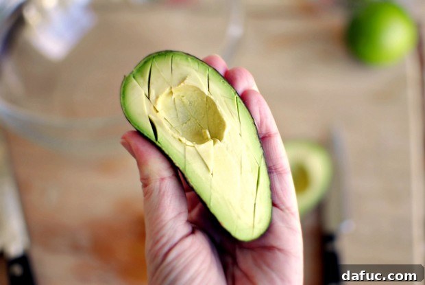 Smoky Blue Guac Perfection 12 Halved avocados with pits removed in a bowl