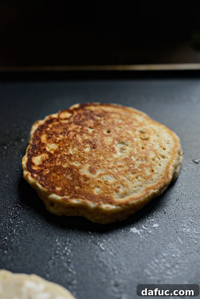 Flipping a pancake on the griddle