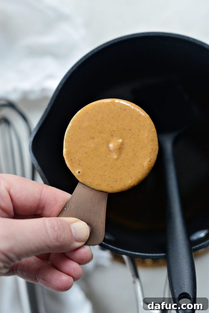 Maple syrup and peanut butter in a saucepan
