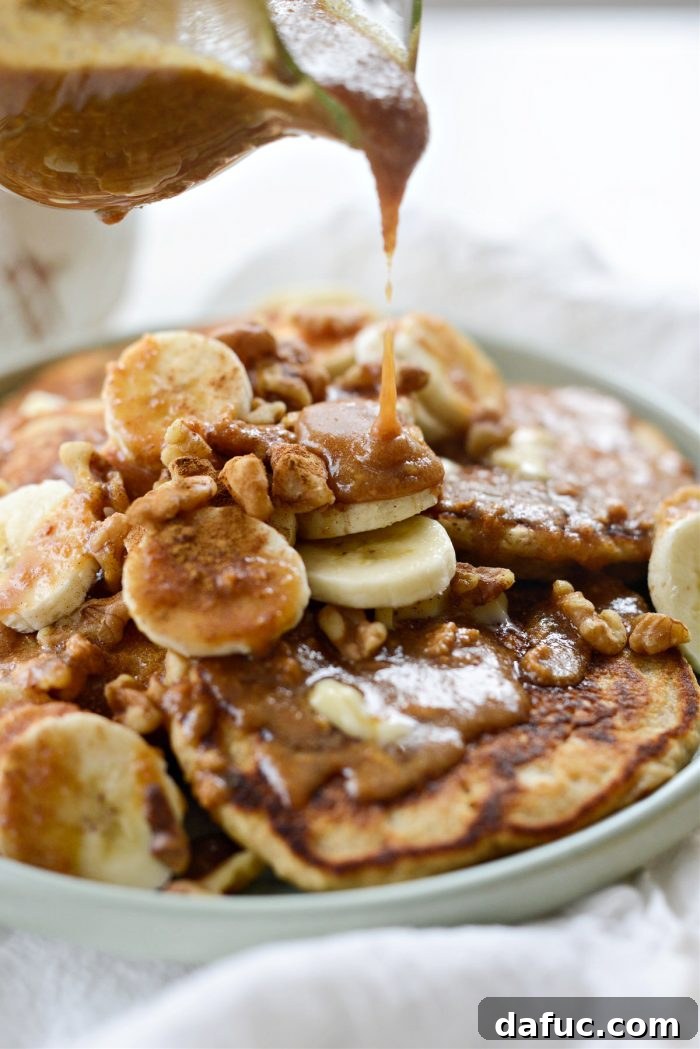 Peanut Butter Oatmeal Banana Pancakes drizzled with syrup and sprinkled with cinnamon