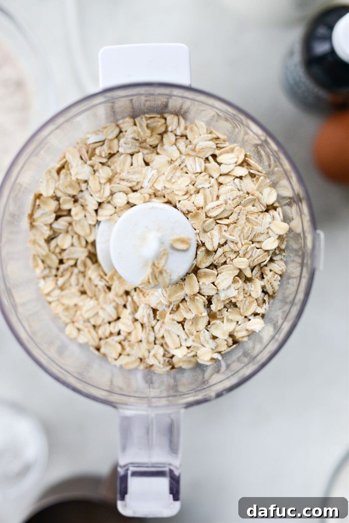 Mixing bowl with ground oats, flour, and other dry ingredients