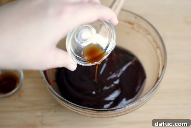 Mystic Mayan Truffles 11 Adding vanilla extract to the rich truffle mixture