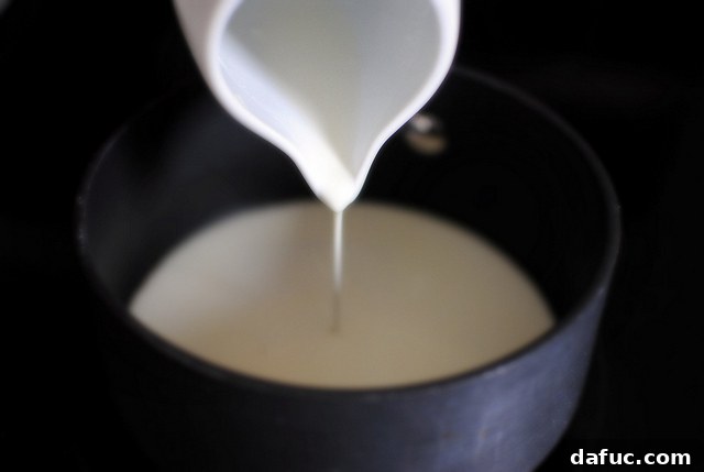 Mystic Mayan Truffles 6 Heavy cream simmering gently in a saucepan, small bubbles forming