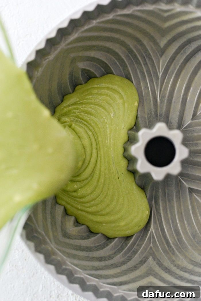 Pouring the cake batter evenly into the well-prepared bundt pan.