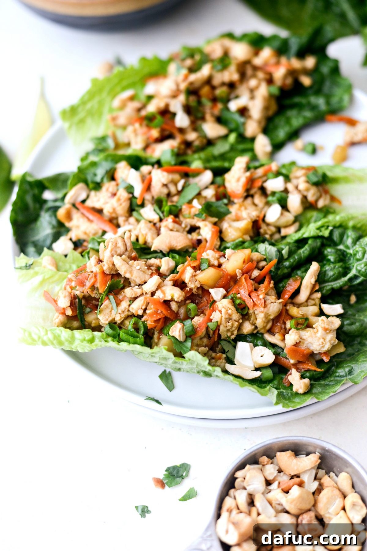 Vibrant Ginger Cashew Lettuce Wraps 15 A vibrant plate of Ginger Cashew Turkey Lettuce Wraps with fresh garnishes