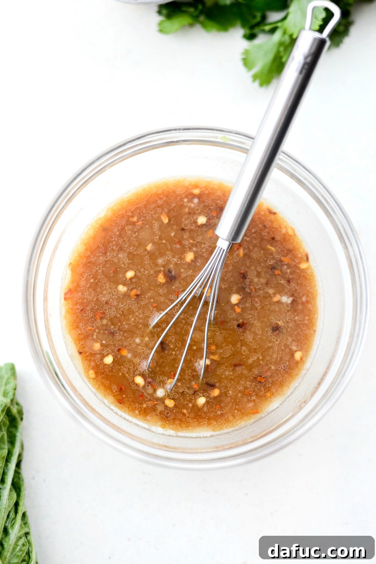 Vibrant Ginger Cashew Lettuce Wraps 5 Homemade sauce for lettuce wraps in a bowl with a whisk