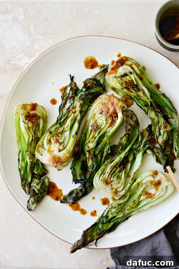 A large platter filled with perfectly grilled baby bok choy, beautifully arranged and ready for saucing