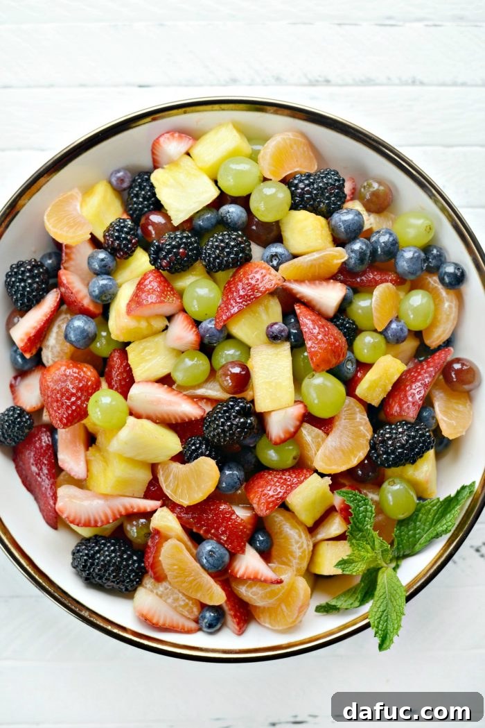 Prismatic Fruit Delight 23 Large bowl of rainbow fruit salad on a wooden table
